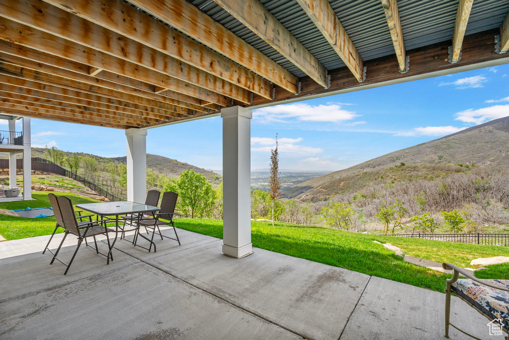 View of patio with a mountain view and outdoor dining space