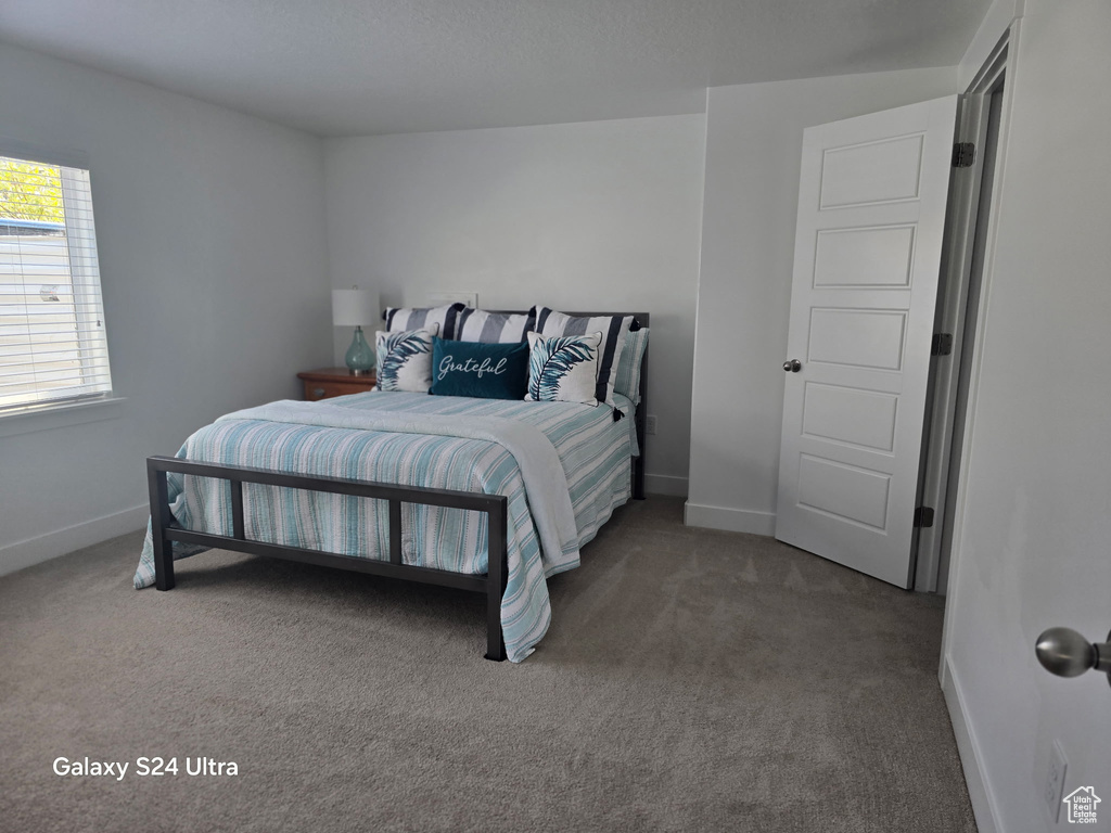 Bedroom with carpet floors and baseboards