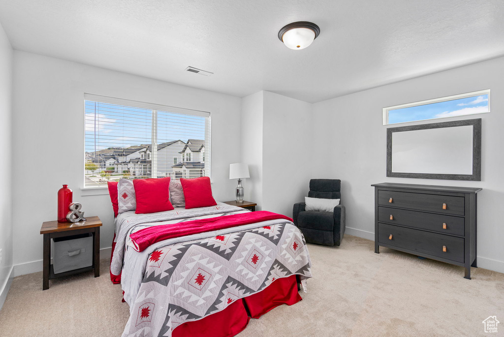 Carpeted bedroom with baseboards