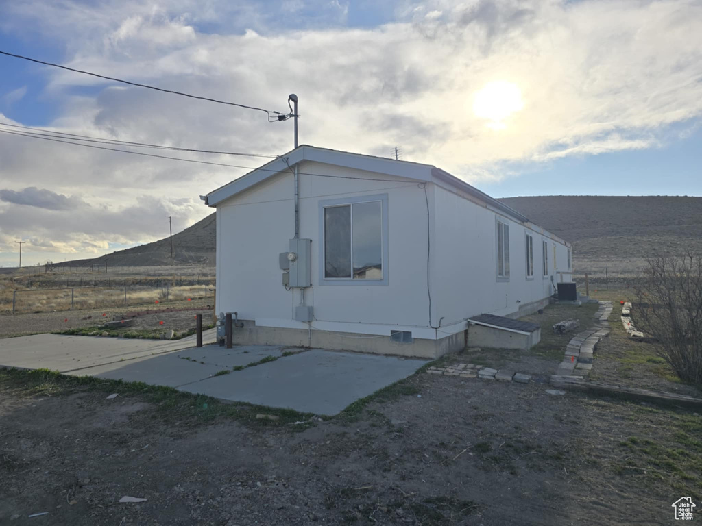 View of property exterior with fence and crawl space