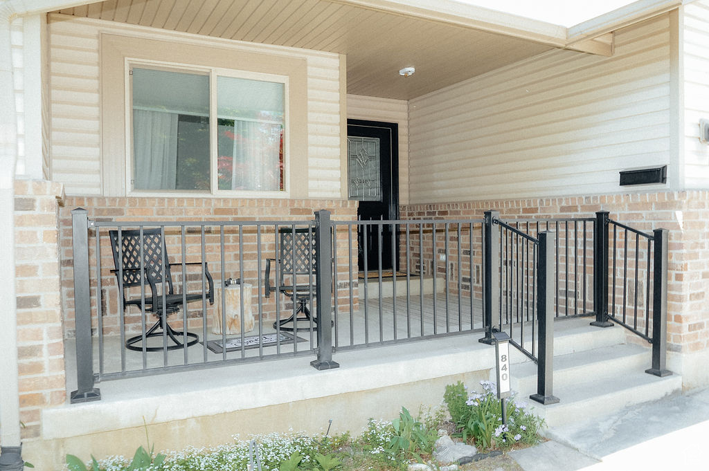 Doorway to property featuring brick siding and a porch