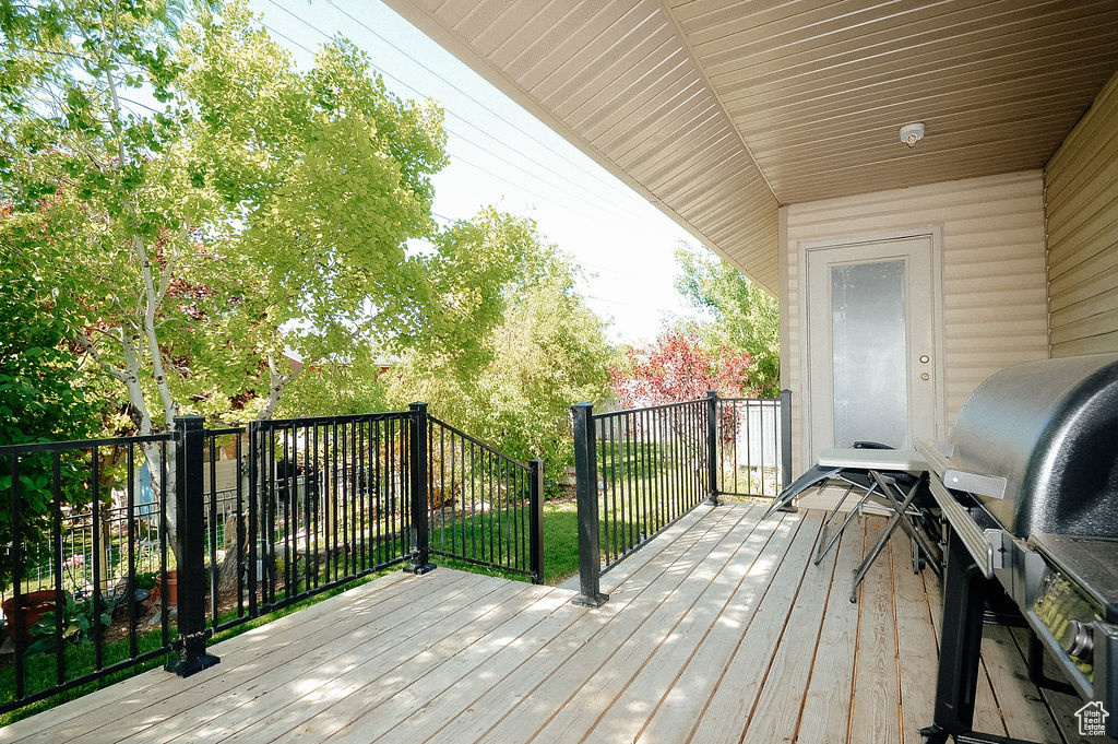 Wooden terrace featuring grilling area
