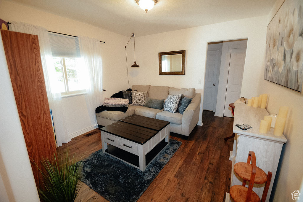 Living area with dark wood finished floors and baseboards