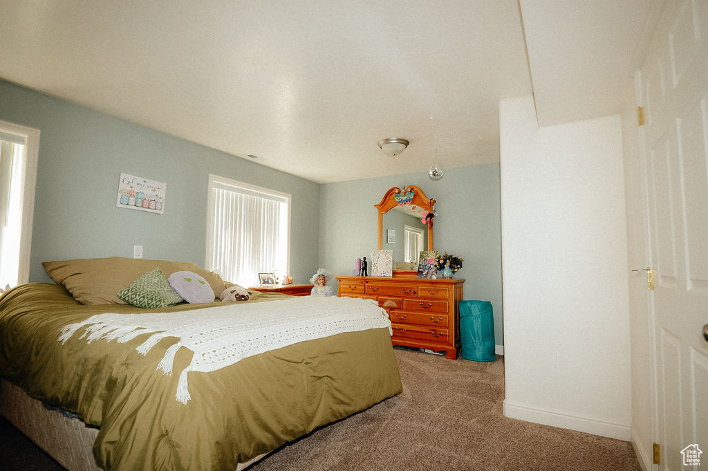 Bedroom with light carpet and baseboards