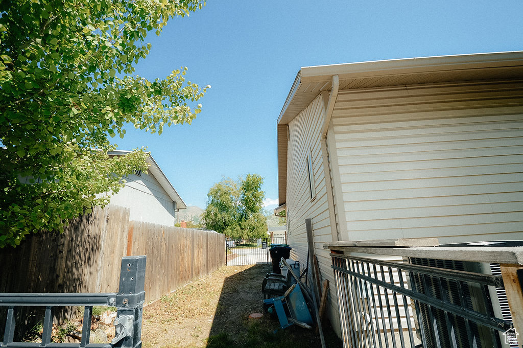View of side of home with fence