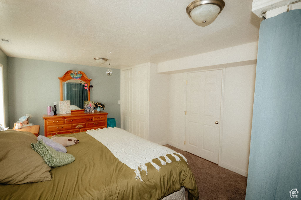 Carpeted bedroom with baseboards