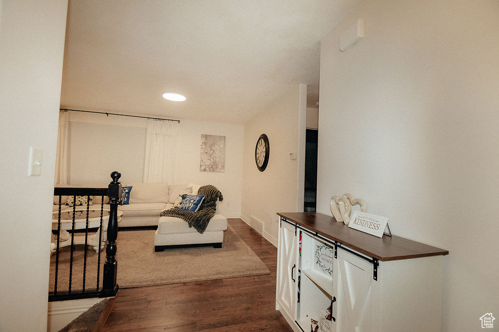 Living area featuring dark wood finished floors, baseboards, and recessed lighting