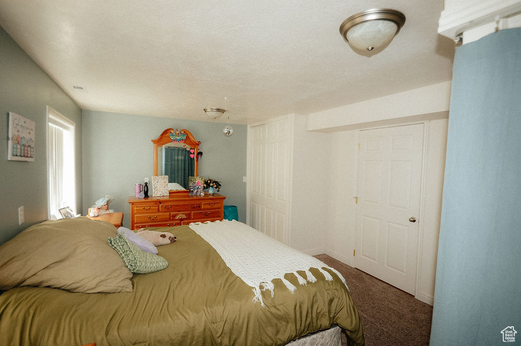 Bedroom featuring carpet flooring and baseboards