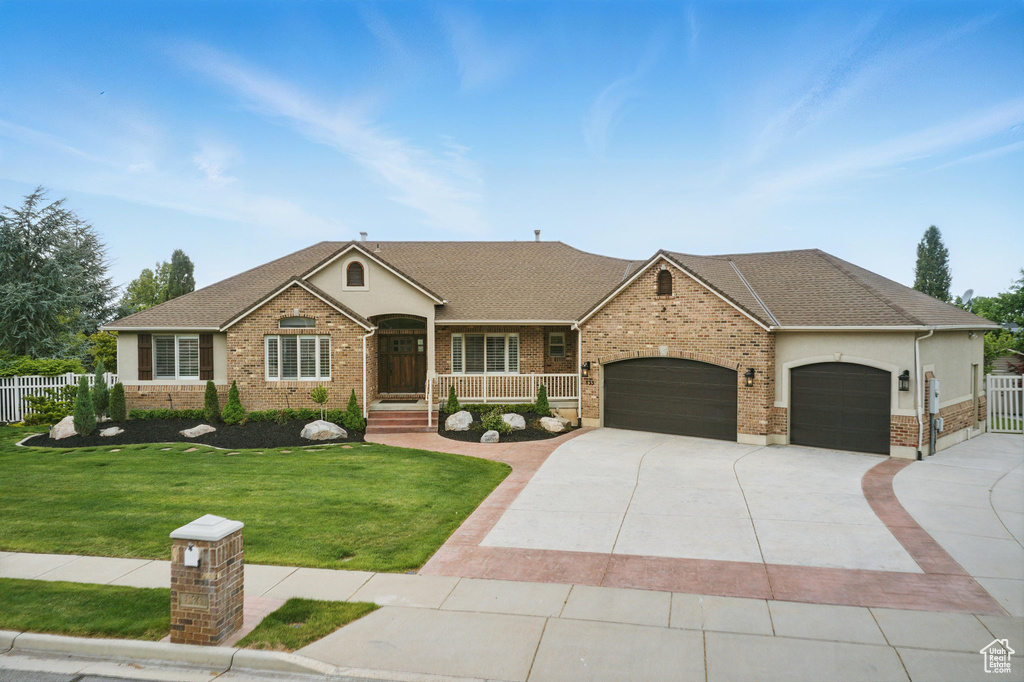 Ranch-style house with a garage, concrete driveway, brick siding, and roof with shingles