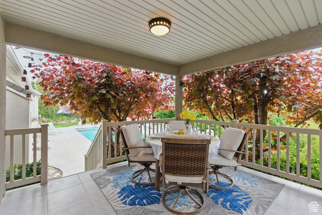 View of patio featuring outdoor dining space, an outdoor pool, and a wooden deck