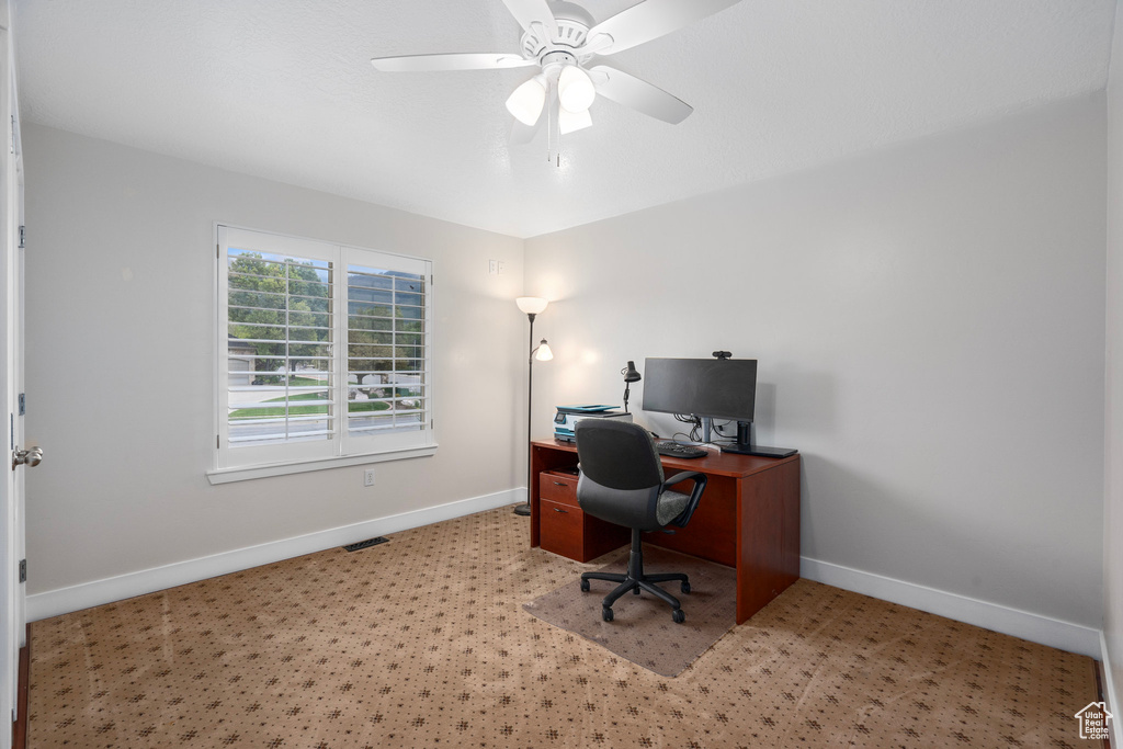 Office area featuring baseboards and a ceiling fan