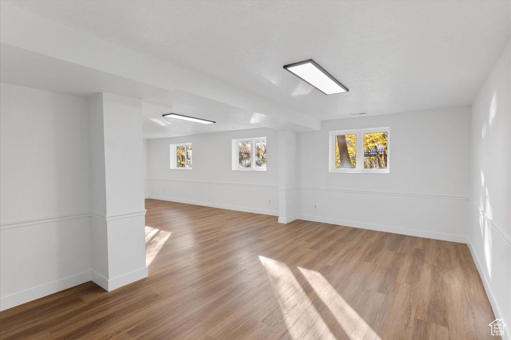 Empty room with light wood-type flooring and baseboards