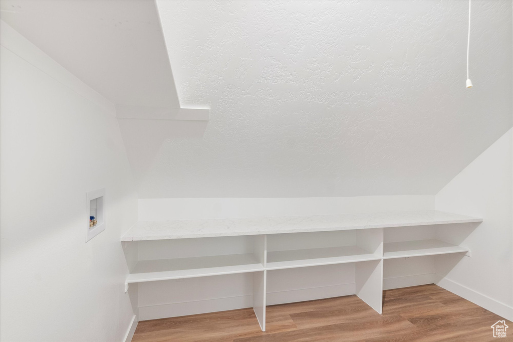 Mudroom featuring wood finished floors and baseboards