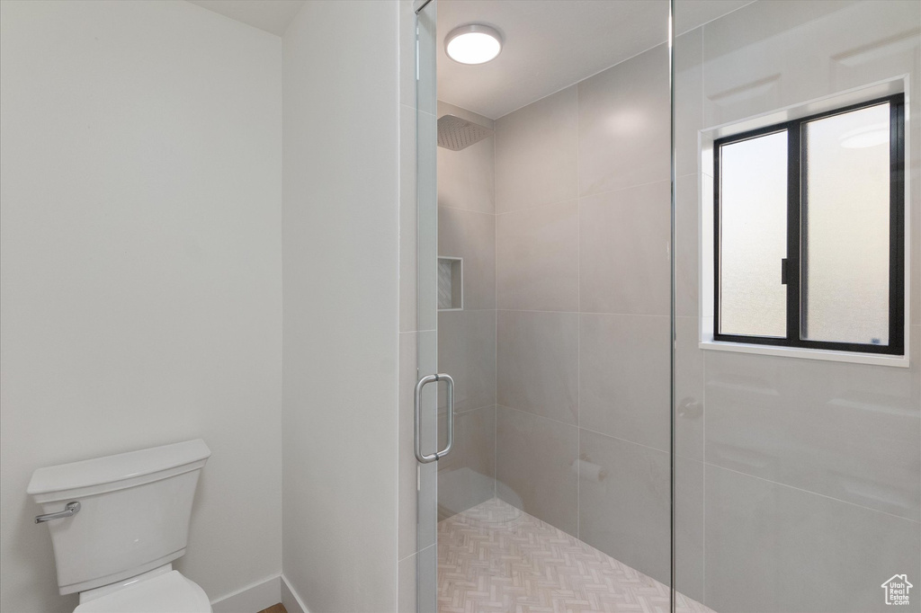 Full bathroom with toilet and a shower stall