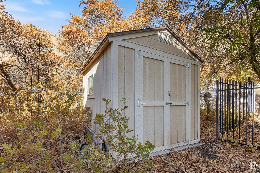 View of shed featuring fence