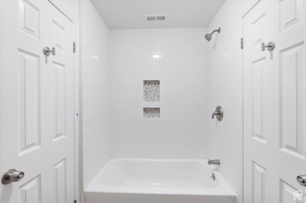 Full bath featuring  shower combination and visible vents