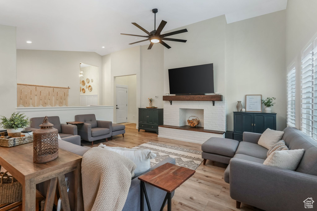 Living area featuring high vaulted ceiling, light wood-style flooring, ceiling fan, and recessed lighting