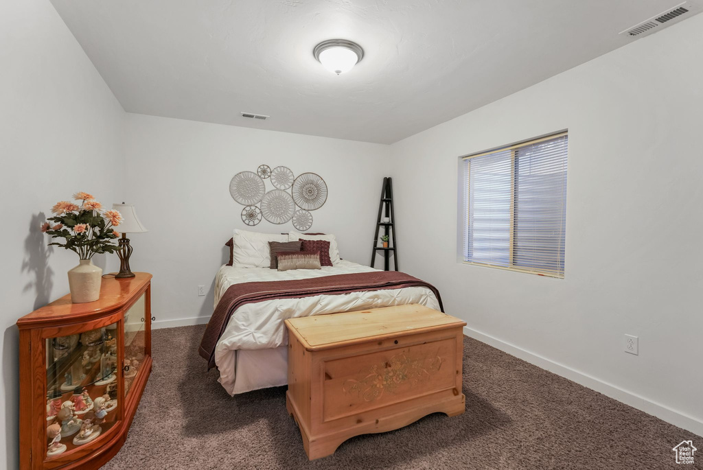 Carpeted bedroom featuring baseboards