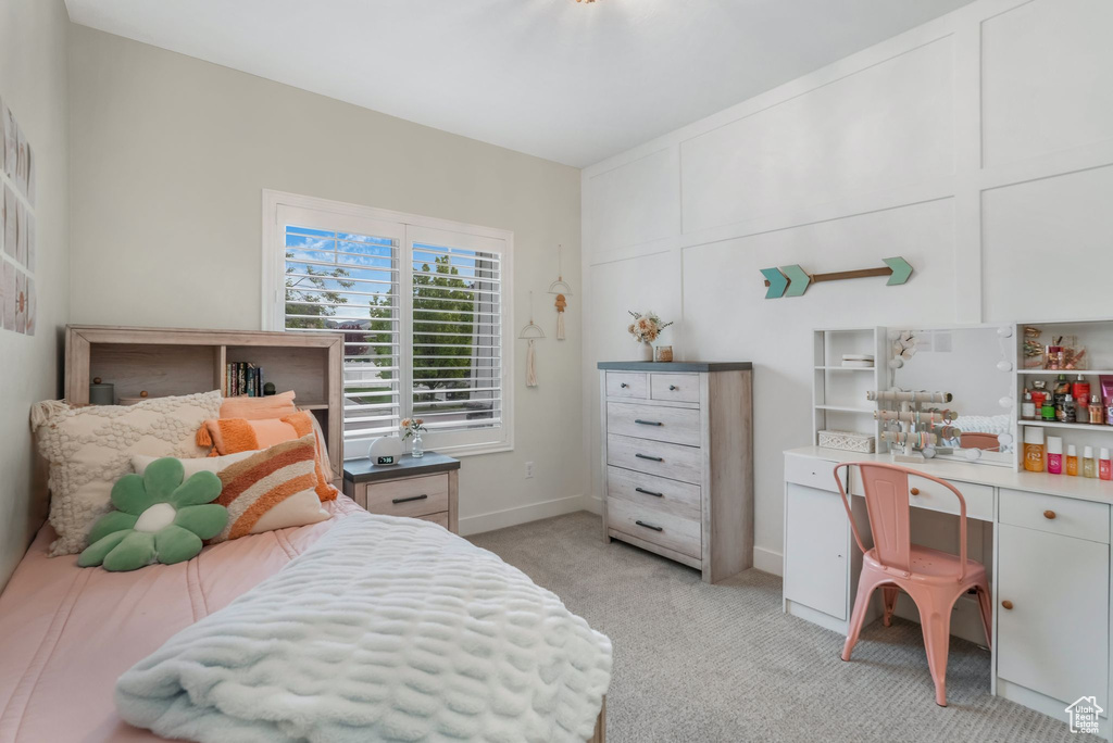 Bedroom featuring light colored carpet and baseboards