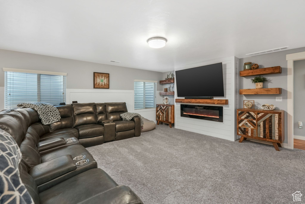 Carpeted living room with a fireplace