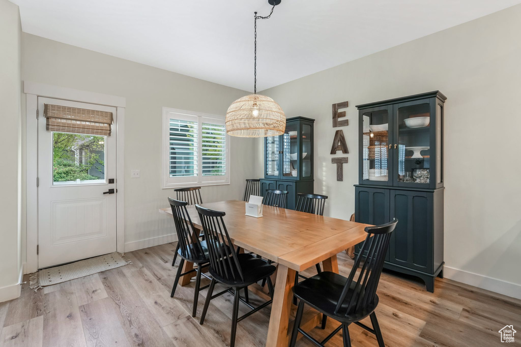 Dining area with light wood-type flooring and baseboards
