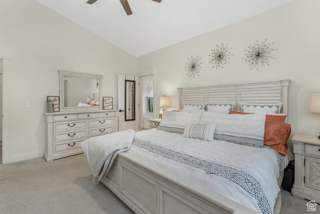 Bedroom with light colored carpet, a ceiling fan, baseboards, and high vaulted ceiling