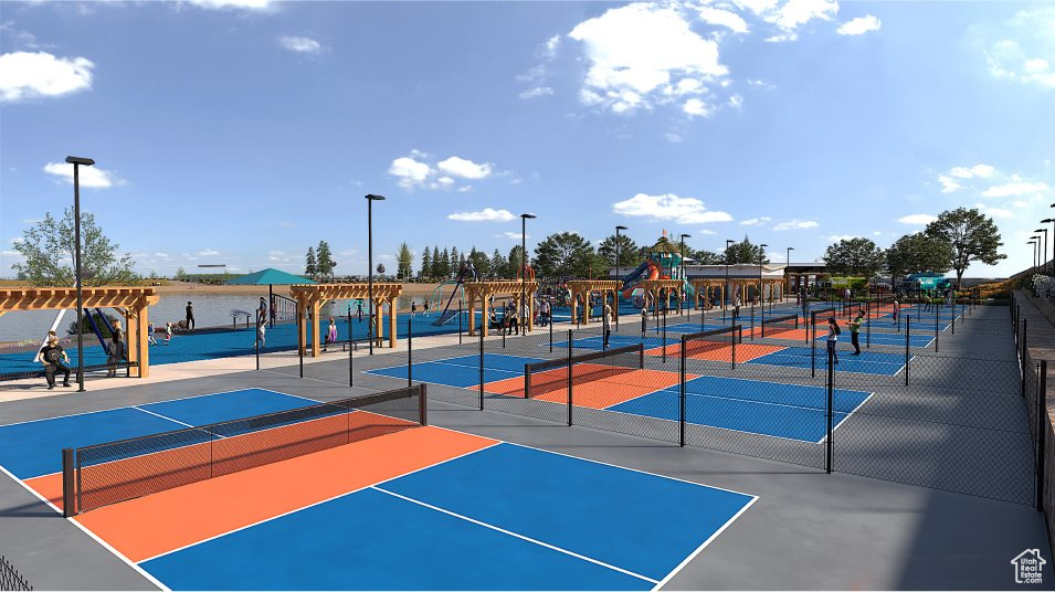 View of tennis court featuring fence, a water view, and community basketball court