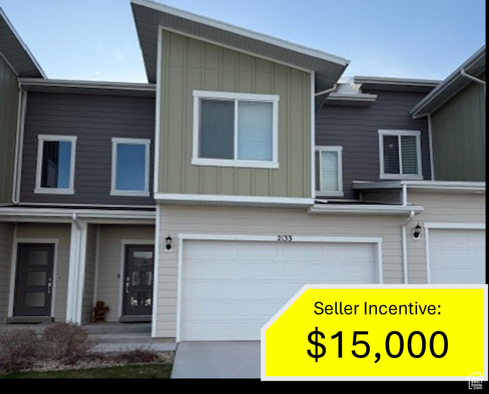 View of front of property featuring a garage and board and batten siding