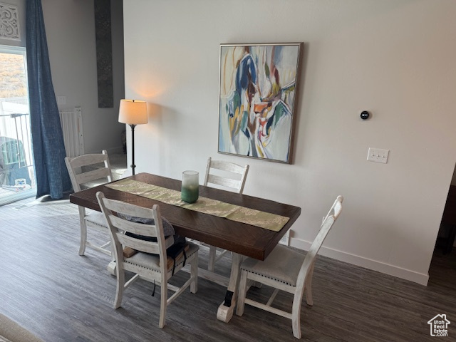 Dining area featuring wood finished floors and baseboards