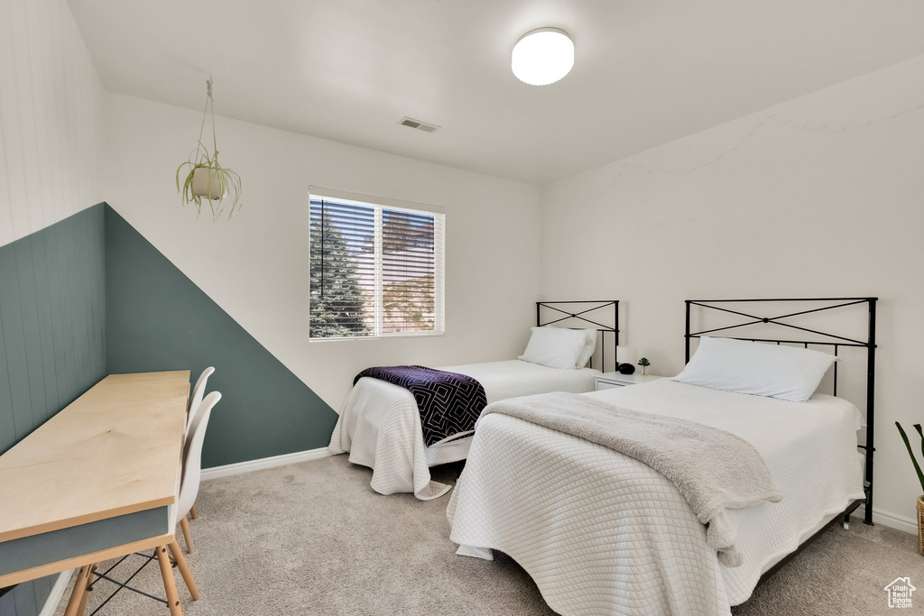 Carpeted bedroom with visible vents and baseboards