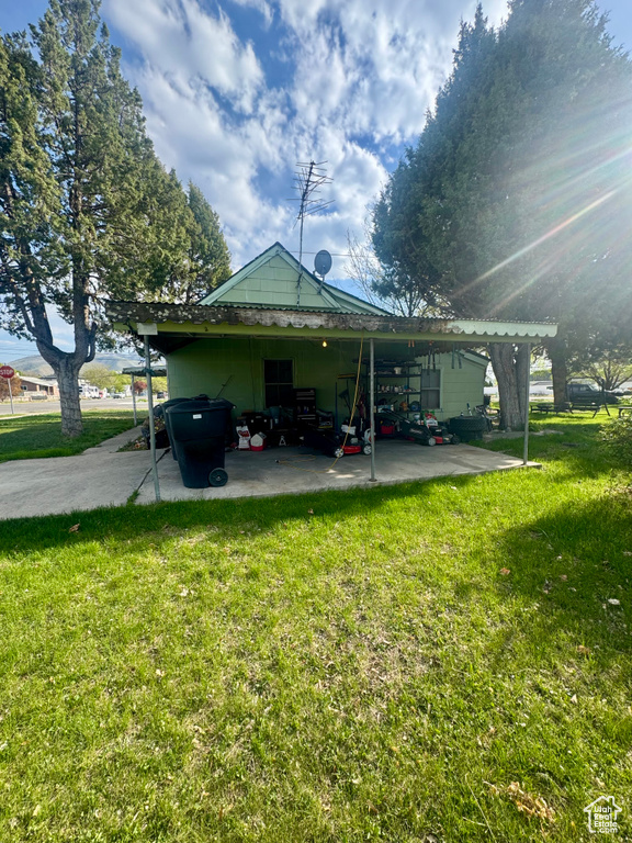 Back of property with a yard and a patio