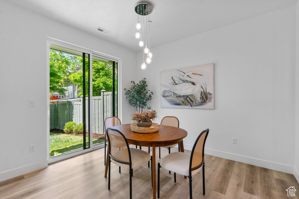 Dining room with baseboards and light wood-style flooring