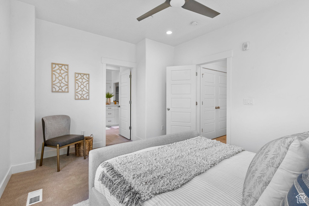 Bedroom featuring baseboards, light carpet, recessed lighting, ensuite bath, and a ceiling fan