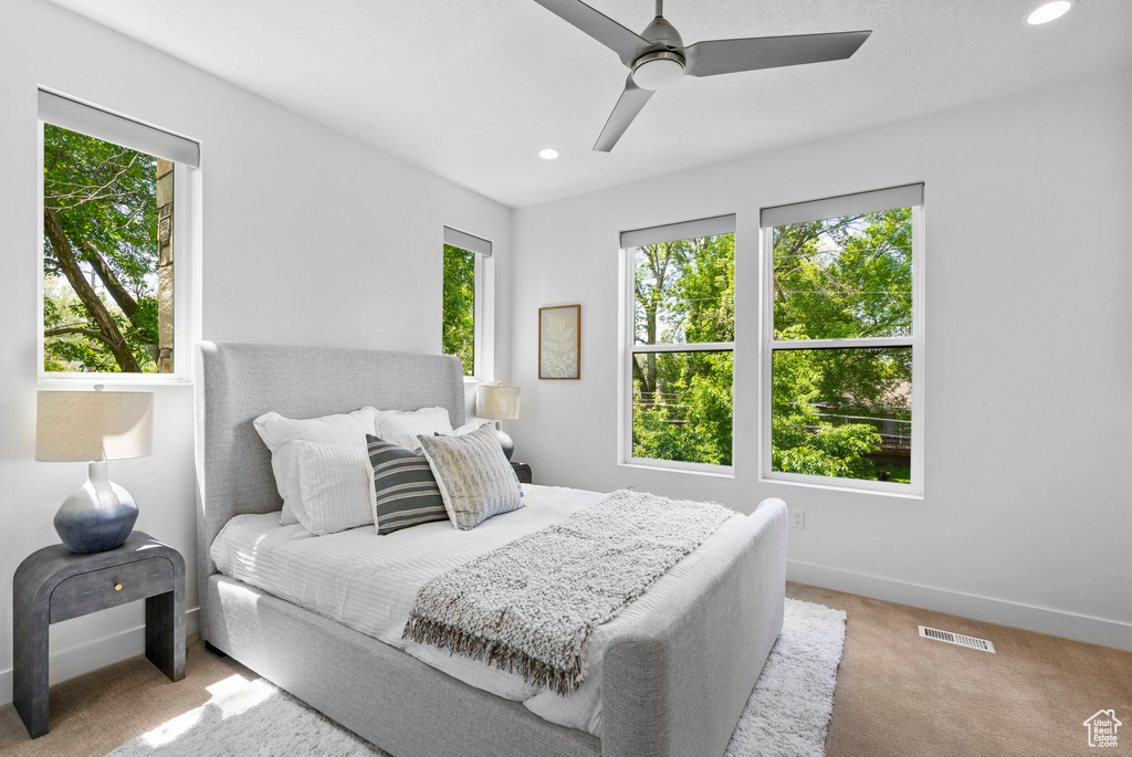 Carpeted bedroom with baseboards, recessed lighting, and a ceiling fan