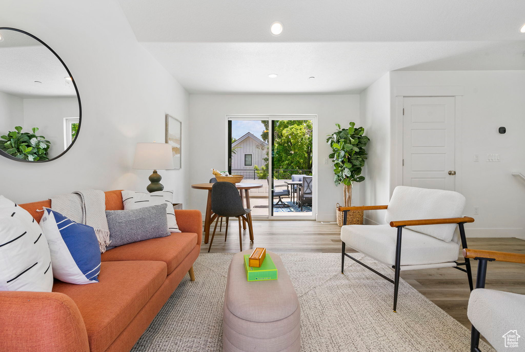 Living area with wood finished floors, recessed lighting, and baseboards