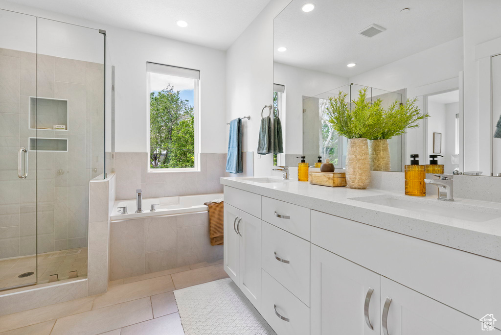 Full bathroom with a shower stall, a bath, recessed lighting, tile patterned floors, and double vanity