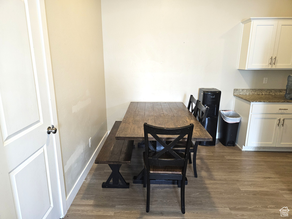 Dining room with dark wood finished floors and baseboards