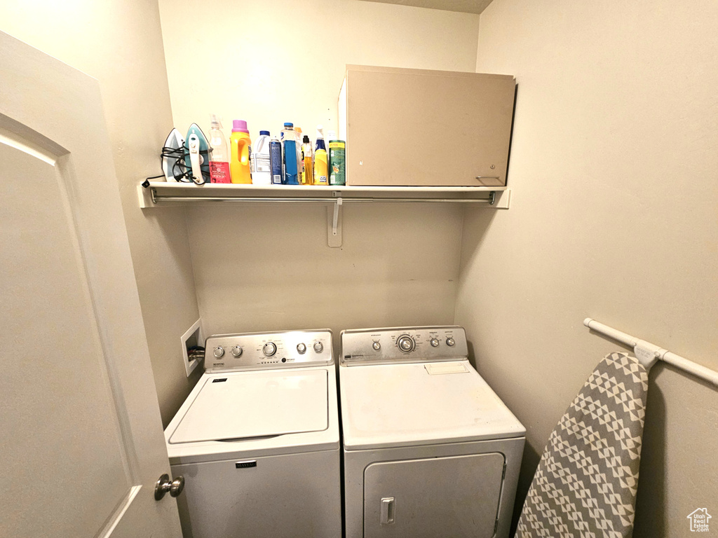 Laundry room with washer and clothes dryer