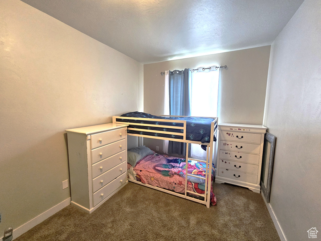 Carpeted bedroom with baseboards