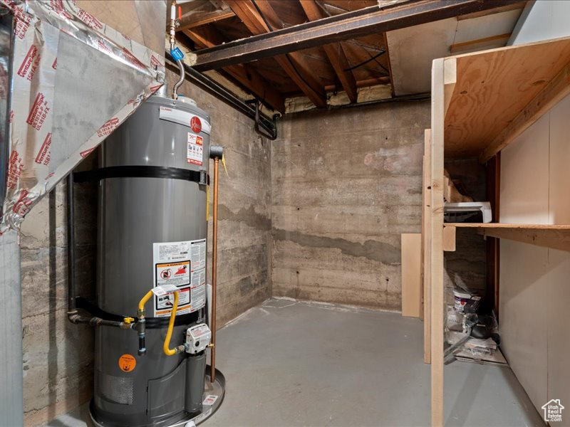 Unfinished basement with strapped water heater
