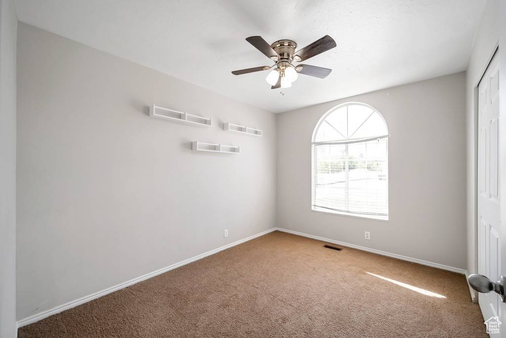 Unfurnished bedroom featuring carpet, baseboards, a closet, and ceiling fan