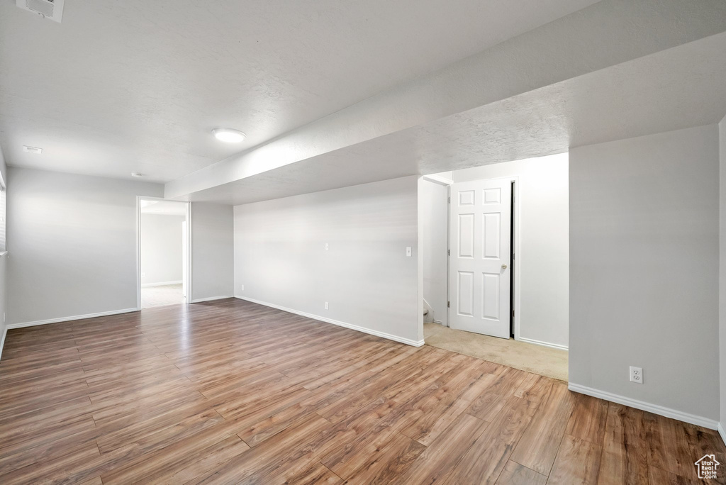 Finished below grade area with wood finished floors and baseboards