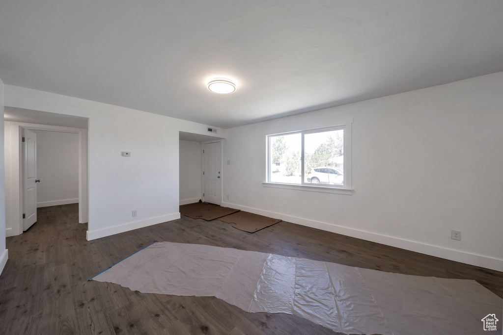 Spare room with baseboards and wood finished floors