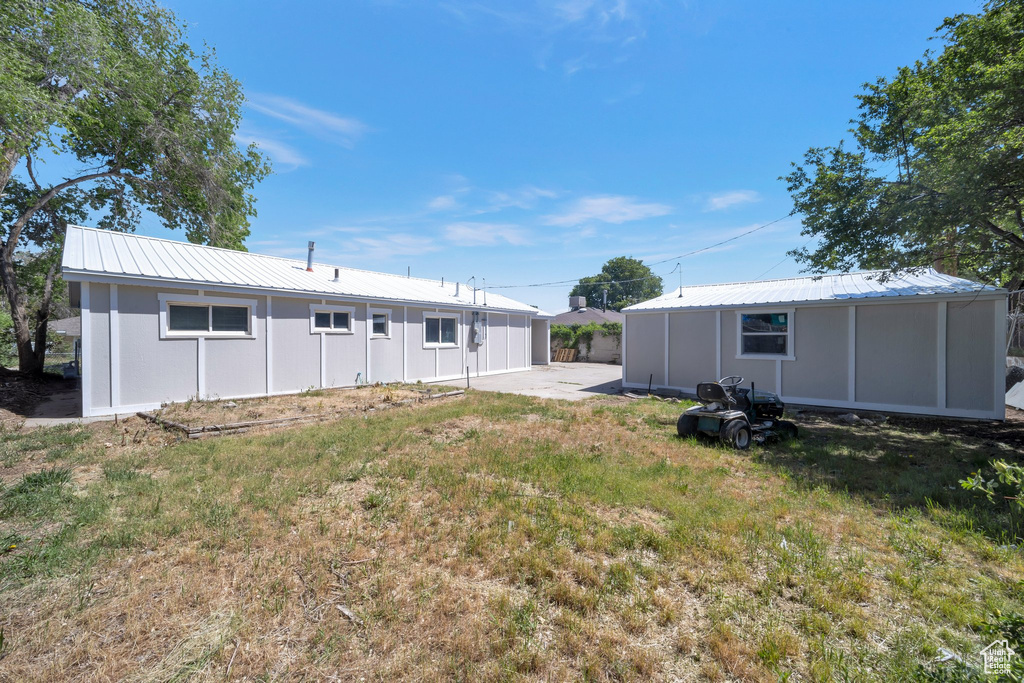 Rear view of property featuring metal roof