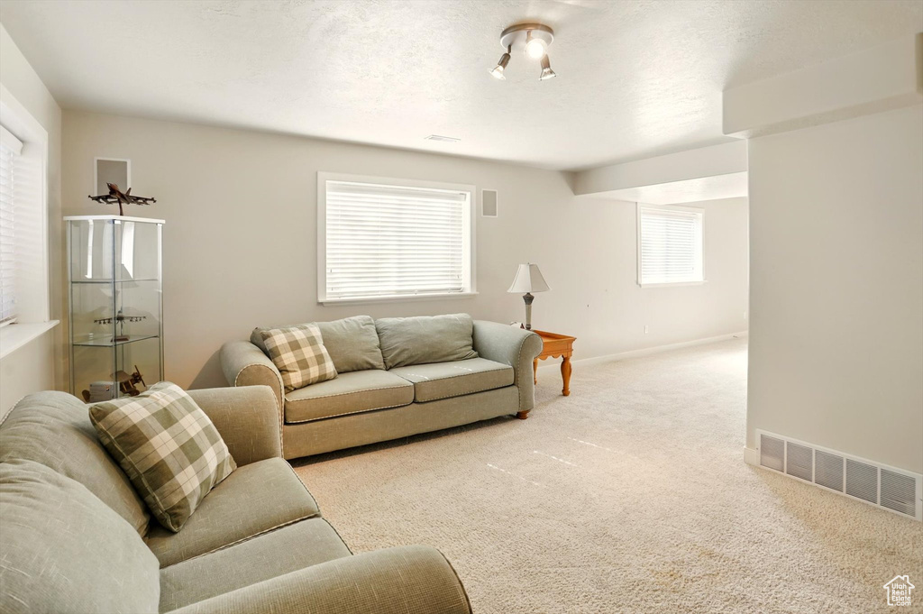 Living room with carpet flooring and baseboards