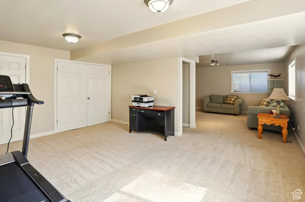 Workout area with carpet flooring and baseboards