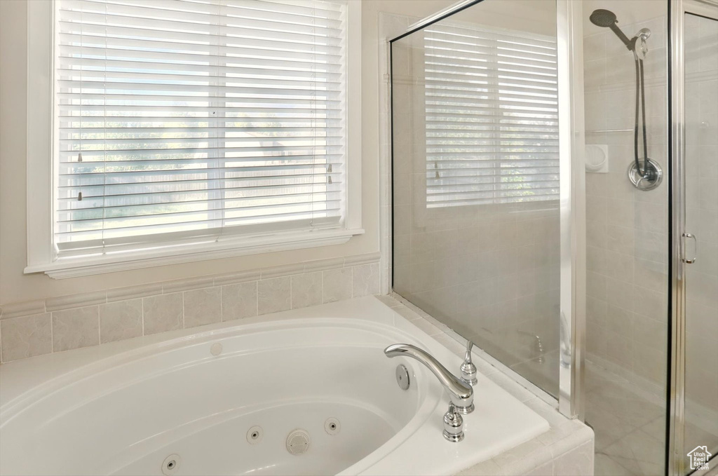 Full bathroom with a tub with jets and a shower stall