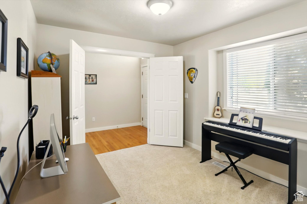 Office with baseboards and carpet flooring