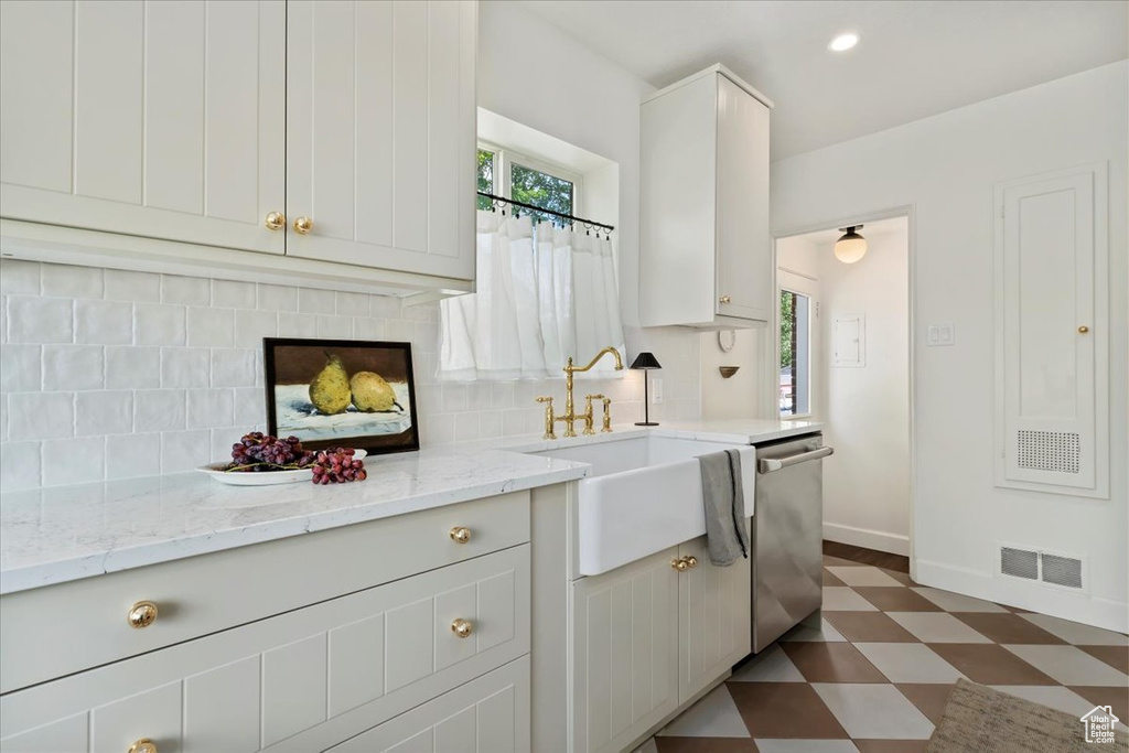 Kitchen with dishwasher, a sink, dark flooring, plenty of natural light, and recessed lighting