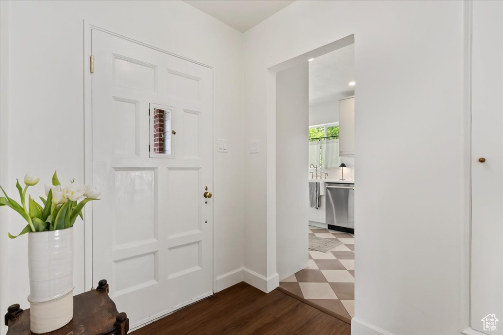Foyer entrance with baseboards and wood finished floors